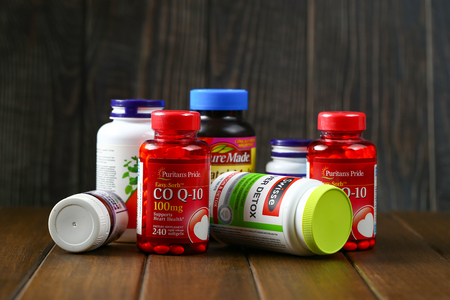 Jinan,China-January 12 2019:bottle for supplement product isolated on brown wooden table backgroundのeditorial素材