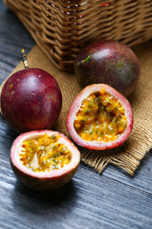 Fresh passion fruit on dark wooden table.の写真素材