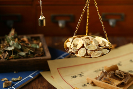 Chinese traditional herbal medicine in steelyard. Translation reads as chinese herbal therapy.の写真素材
