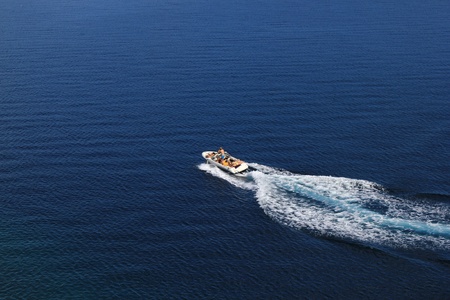 Speed boat aerial view on blue open sea waterの写真素材