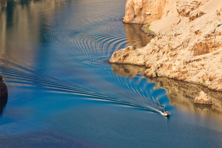 Boat leaving waves in Zrmanja river canyon, Dalmatia, Croatiaの写真素材