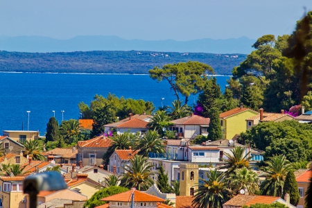 Colorful coastal town of Mali losinj residential area by the blue seaの写真素材
