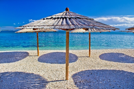 Pebble beach and turquoise sea umbrella, Zrce beach, Island of Pag, Croatiaの写真素材