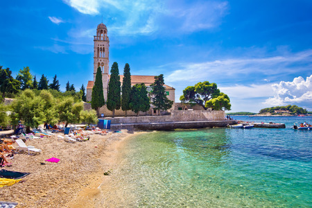 Hvar island turquoise beach and stone church, Dalmatia, Croatiaの写真素材