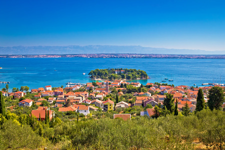 Island of Ugljan picturesque coast with Zadar and Velebit mountain, Dalmatia, Croatiaの写真素材