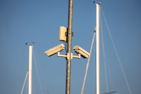 Pair of outdoor security cameras in yachting harborの写真素材