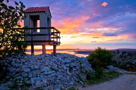 Lookout tower above Pakostane archipelago at golden sunset, Dalmatia, Croatiaの写真素材