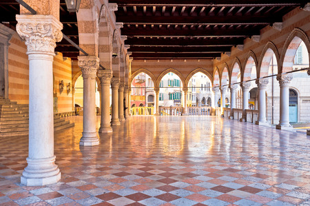 Ancient Italian square arches and architecture in town of Udine, Piazza della Liberta square, Friuli Venezia Giulia region of Italyのeditorial素材
