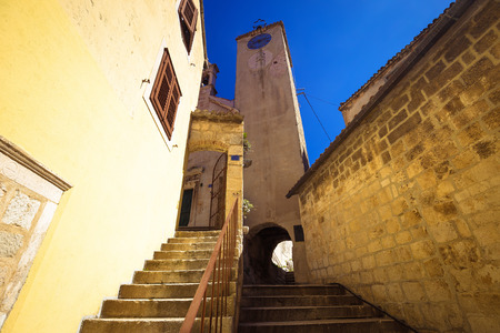 Old stone carved street and tower of Omis old town, Dalmatia region of Croatiaの写真素材