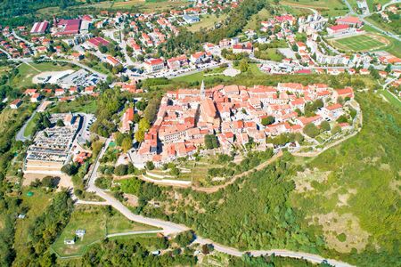 Buzet. Hill town of Buzet surrounded by stone walls in green landscape aerial view. Istria region of Croatia.の写真素材