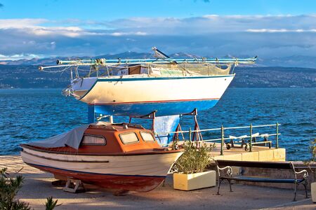 Sailboat and small boat on dry dock by the sea, Opatija, Croatiaの写真素材