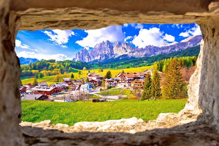 Beautiful landscape of Cortina d' Ampezzo in Dolomites Alps view through stone window, Veneto region of Italyの写真素材