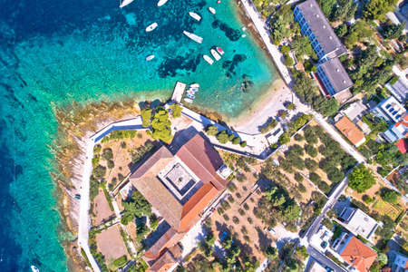 Aerial view of Franciscan monastery and amazing turquoise beach in town of Hvar, Dalmatia...