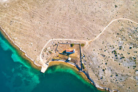 Stone desert island of Zecevo church and pilgrimage aerial view, Zadar archipelago of Croatia