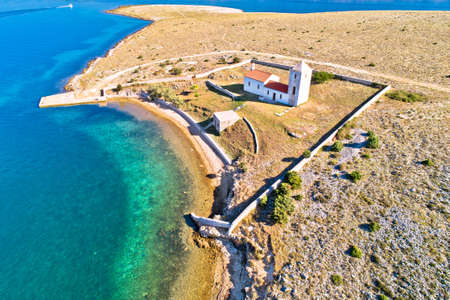 Stone desert island of Zecevo church and pilgrimage aerial view, Zadar archipelago of Croatia