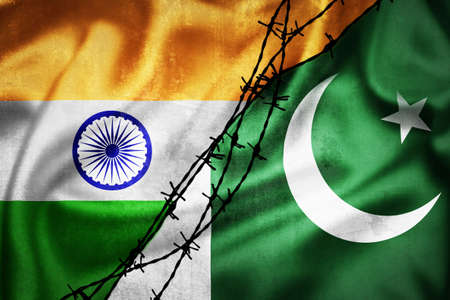 Grunge flags of India and Pakistan divided by barb wire illustration, concept of tense relations between India and Pakistanの写真素材