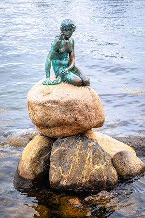 Copenhagen, Denmark, August 29 2023: Little mermaid statue displayed on a rock by the waterside at the Langelinie promenade in Copenhagen, Denmark, capital of Denmark. Statue was made in bronze by Edvard Eriksen in 1909の写真素材