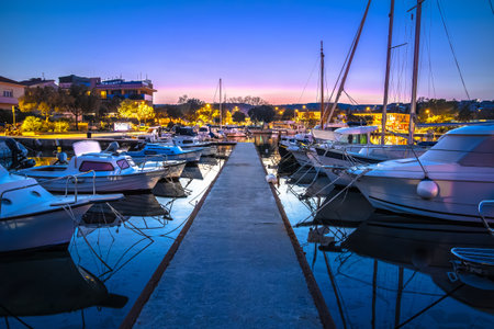 Colorful dusk harbor view in town of Krk, archipelago of Kvarner bay in Croatiaの写真素材