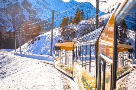 Wengen railway to Jungfraujoch peak train in winter landscape view, Berner Oberland region of Switzerlandの写真素材
