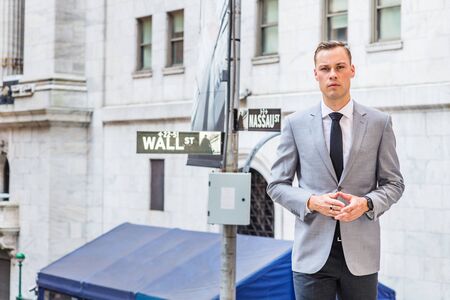 Young Businessman Street Fashion in New York City. Young Man wearing gray blazer, white undershirt,...