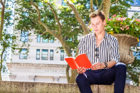 Young European Graduate Student studying in New York City, wearing striped, long sleeve shirt, blue...