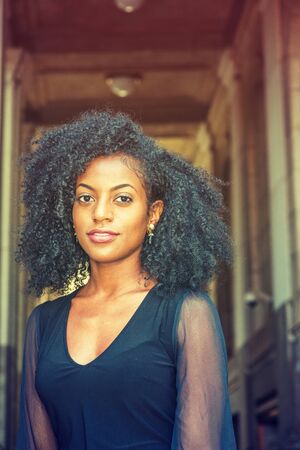 Portrait of Young African American Woman in New York. Young black female college student with afro...