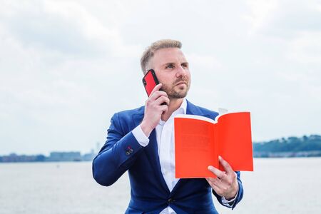 Young American Businessman with beard traveling, relaxing outside in New York City, wearing blue...