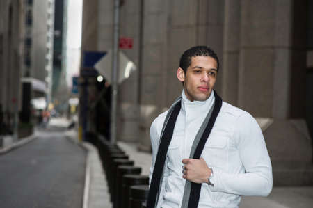A young college student is sitting by a street and into deeply thinking