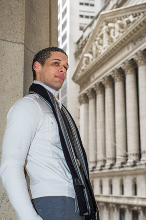 A young college student is standing outside and looking forward.の写真素材