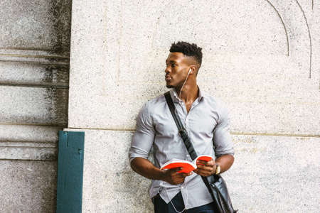 Modern College Student in New York. Wearing gray shirt, wristwatch, carrying shoulder leather bag,...
