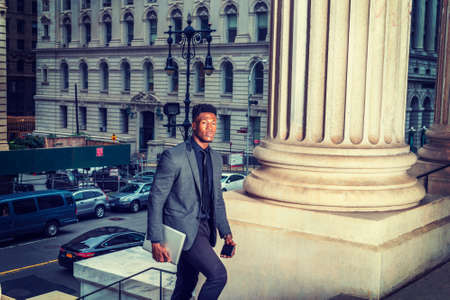 African American Businessman traveling, working in New York, wearing fashionable jacket, necktie,...