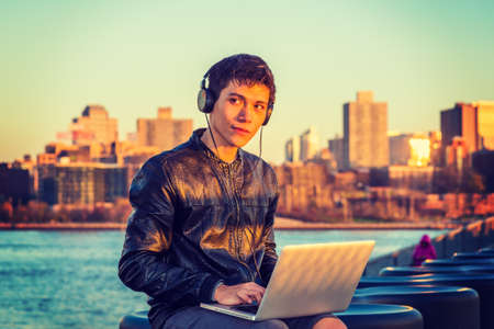 Asian American college student traveling, studying in New York, wearing black leather jacket,...