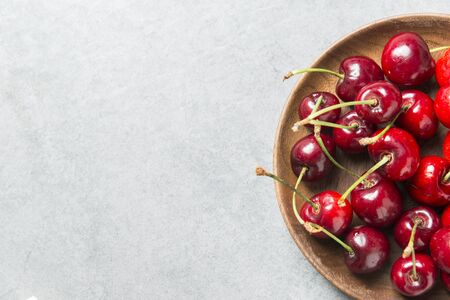 Cherry on wooden plateの写真素材