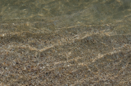 Crystal clear sea water with seashell under itの写真素材