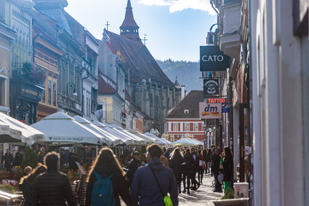 Brasov, Romania - 5 Nov 2023 - Visitors walking between restaurants and stores on Strada Republicii