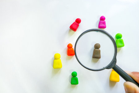 Magnifying glass and colorful people on white background. Selective focus.