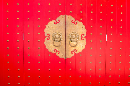 red door knocker in a chinese temple, closeup of photo