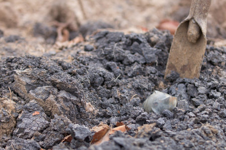 Garden shovel digging in the ground. Selective focus with shallow depth of field.の写真素材