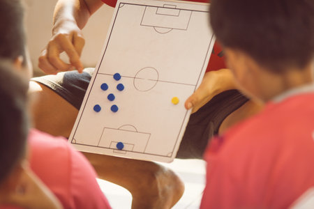 High angle view of a group of young men playing table football togetherの写真素材