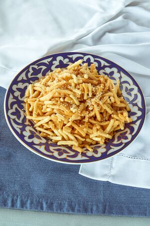 Tatar national dish chak chak in a plate with ornaments Beautiful concept backgroundの写真素材