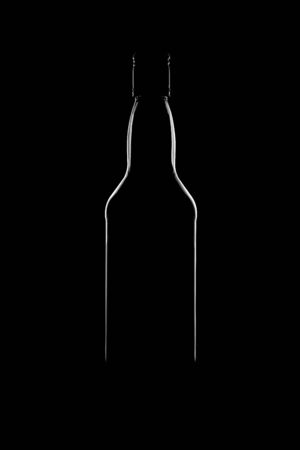 Silhouette of a bottle with a beautiful shape on a black background. High quality photoの写真素材