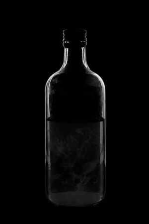 Silhouette of a bottle with a beautiful shape on a black background. High quality photoの写真素材