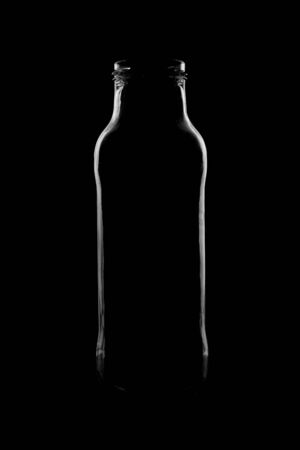 Silhouette of a bottle with a beautiful shape on a black background. High quality photoの写真素材