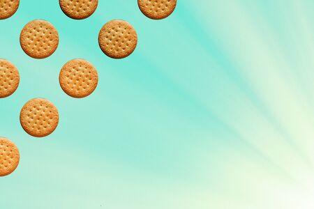 pattern with framed round cookies on a light blue background with sunlight. Place for text. High...