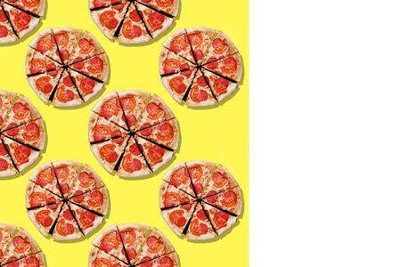 pattern of multiplied slices of pizza salts. Yellow and white background. Place for text. High...