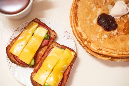 Homemade pancakes with a cup of tea on a light table. High quality photoの写真素材