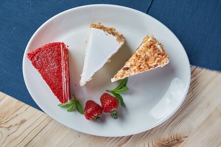 composition of desserts cakes on a blue and wooden background. High quality photo