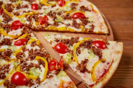 Pizza on a wooden background. Top view. Close-up. High quality photoの写真素材