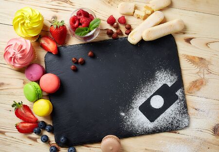 composition of desserts on a light background. Cakes with fruit and a cup of tea. High quality photo. With copy spaceの写真素材