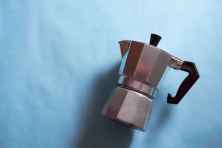 The geyser coffee maker lies on a blue background. With copy space.の写真素材